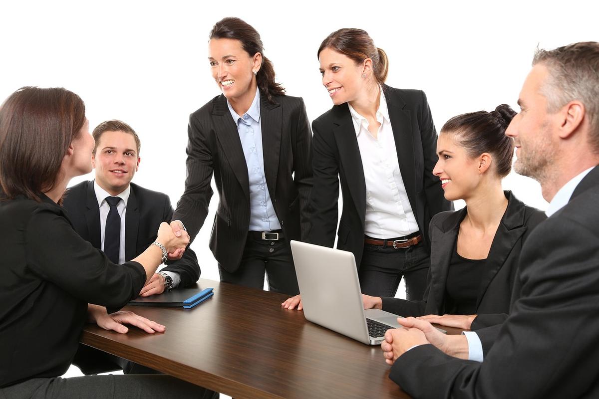 Équipe de professionnels en réunion autour d'une table avec ordinateur portable
